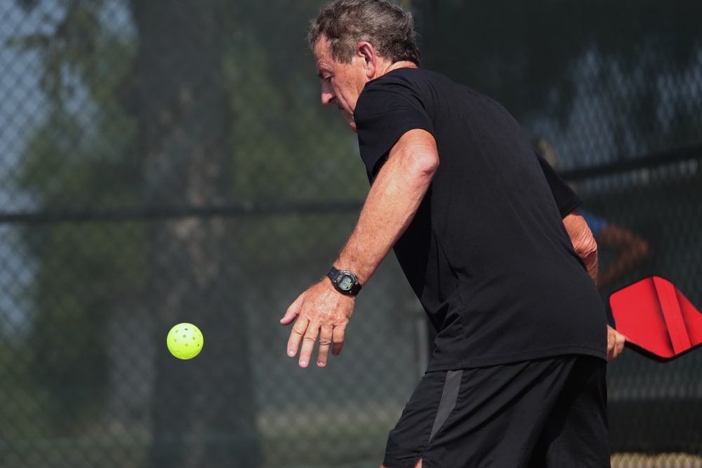 A view of a person playing pickleball singles