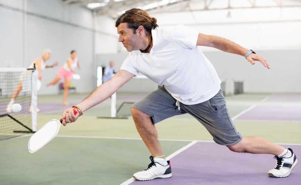 Athletic Man And His Partner Playing Pickleball Tennis On The