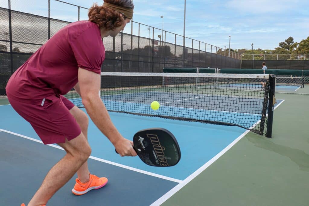 a player is playing the pickleball game in pickleball court