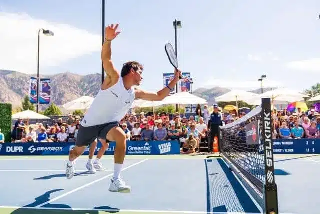 A view of a guy hitting a erne pickleball shot