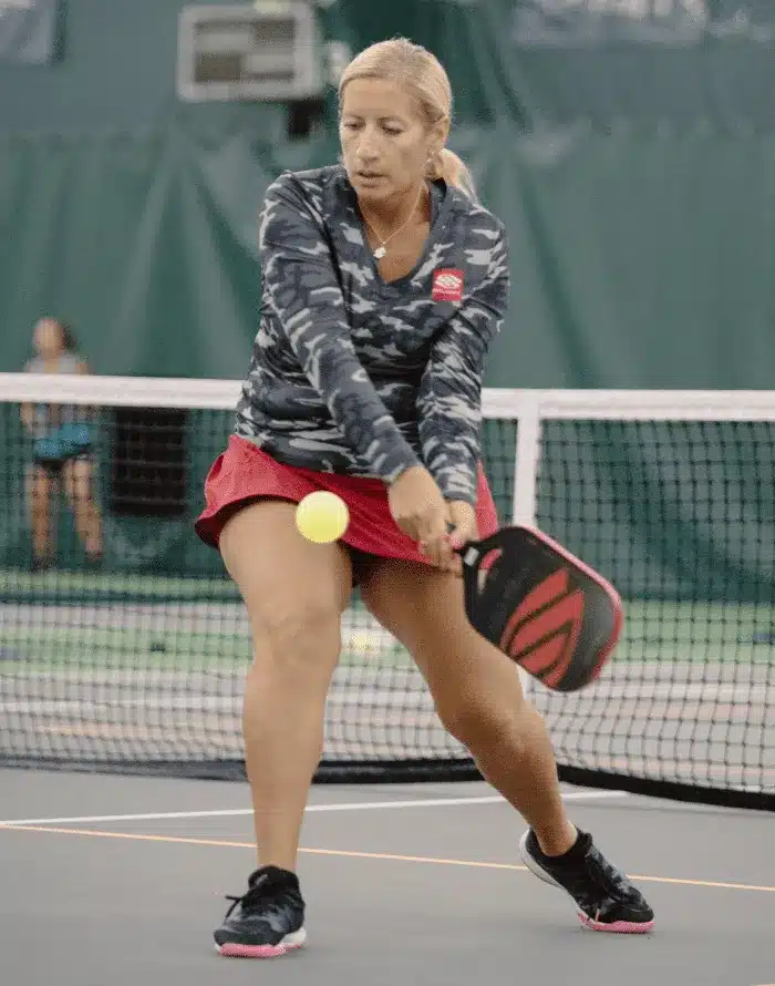 A view of a woman hitting a pickleball shot