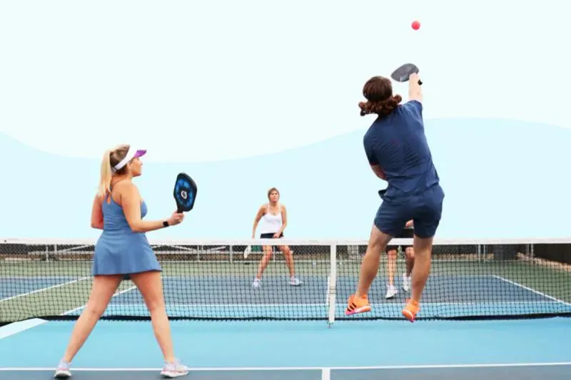 A view of people playing a lob shot in pickleball