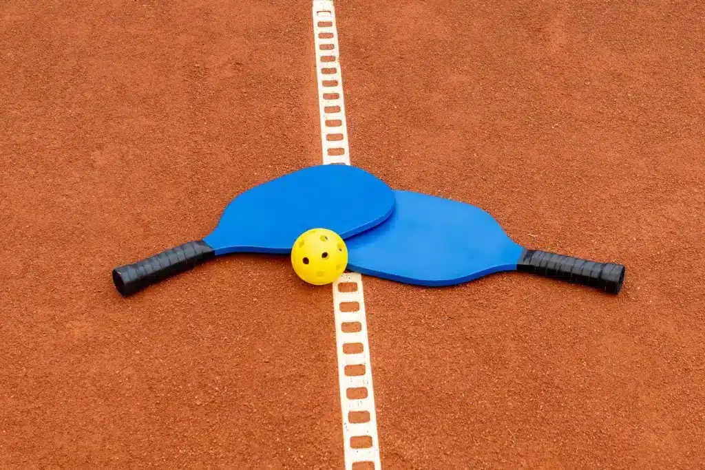 A view of pickleball paddles and a ball