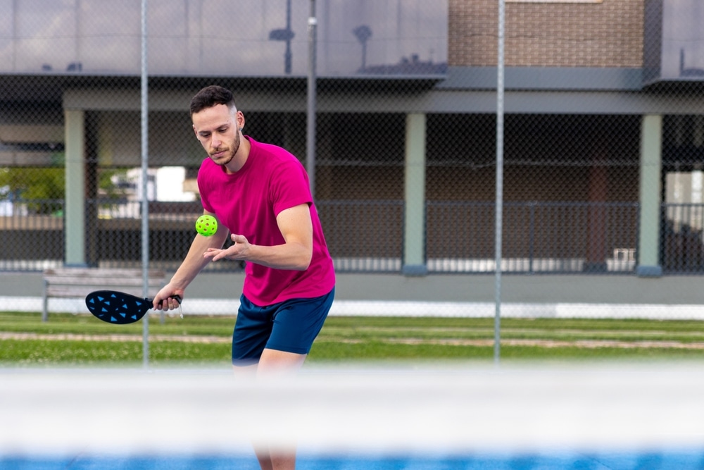 A view of a person serving in pickleball