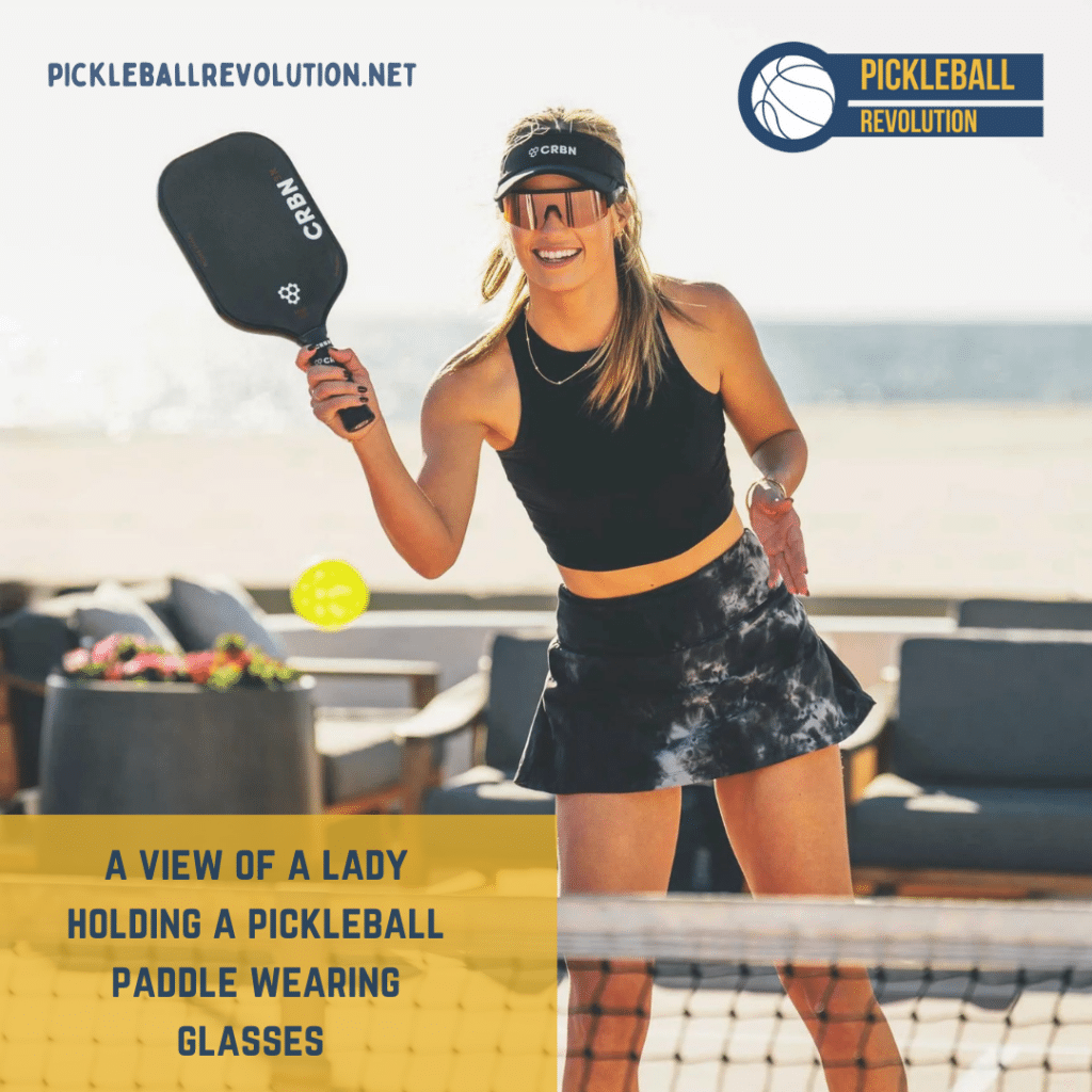 A view of a lady playing pickleball wearing glasses