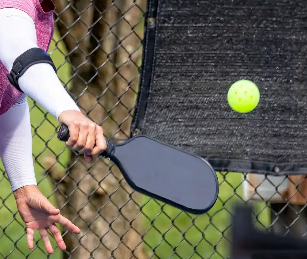 A view of a person hitting a shot with pickleball paddle