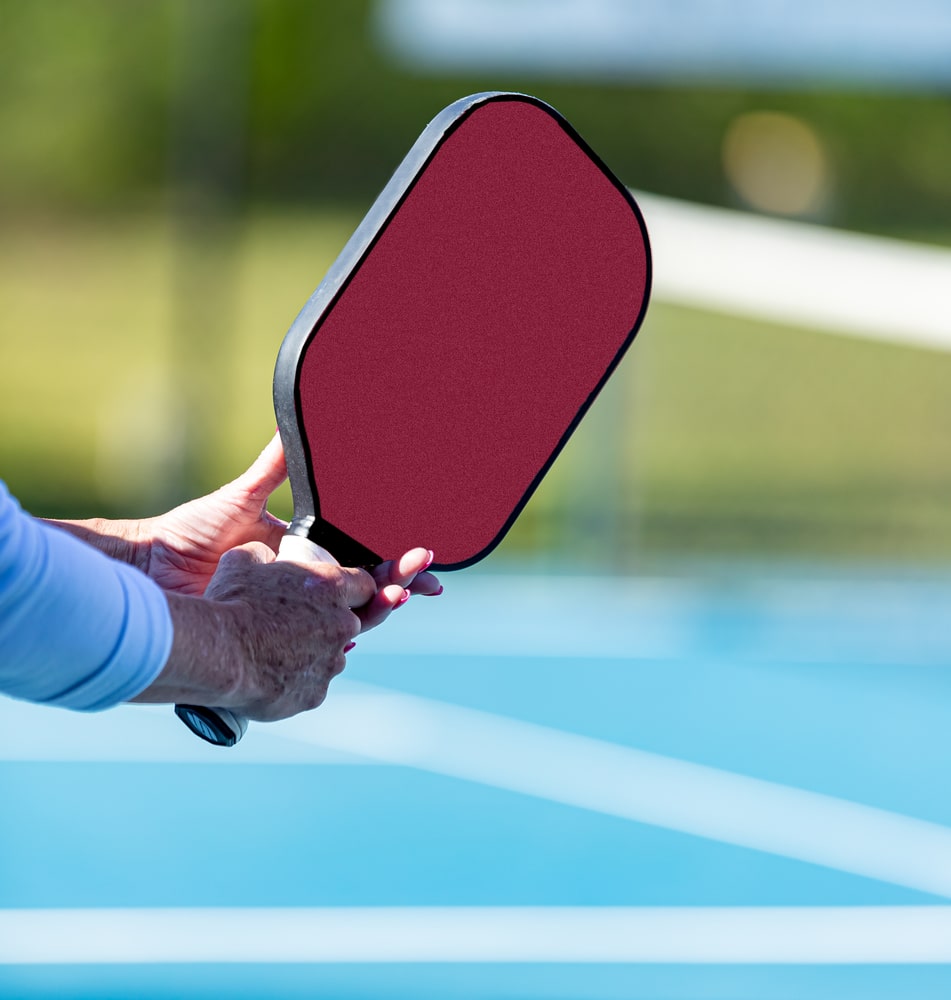 A view of a person holding a pickleball paddle