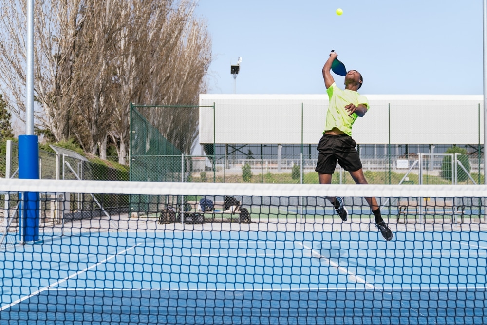 A view of a person hitting pickleball smash shot