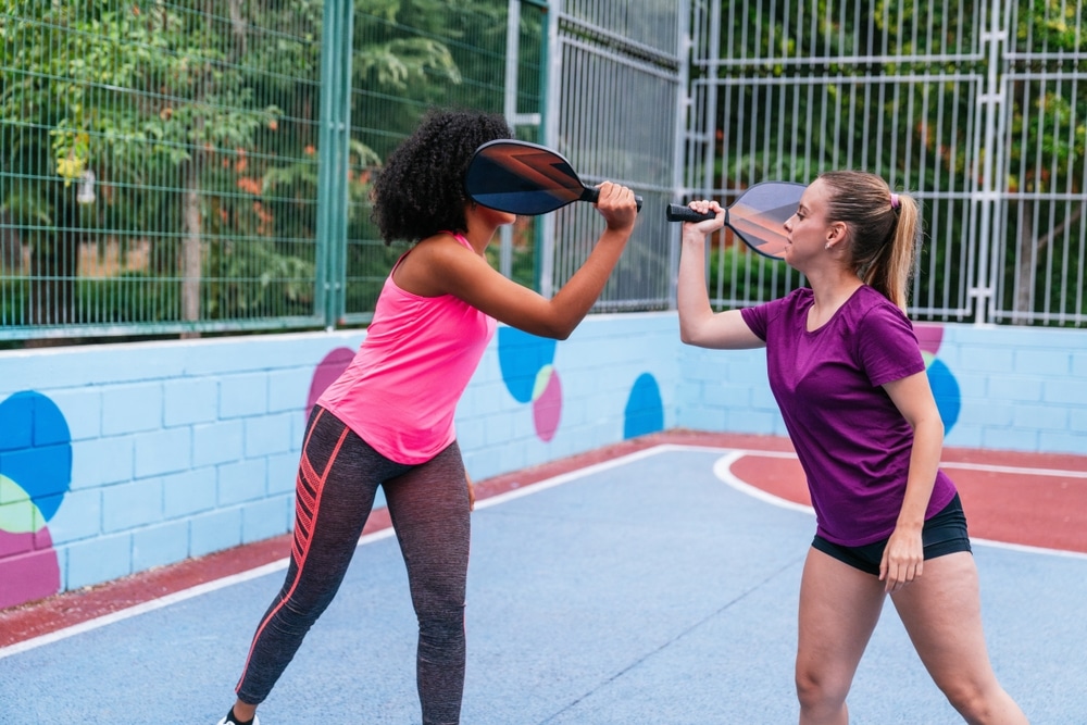 A view of two girls playing pickleball